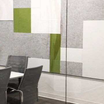 Modern Office with Green and Gray Wall Panels and Clear Glass Partition