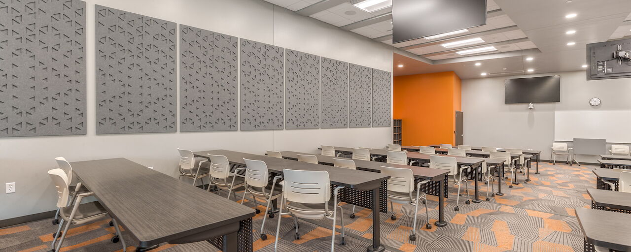 Modern Classroom Interior with Gray Tables, Chairs and Decorative Wall Panels