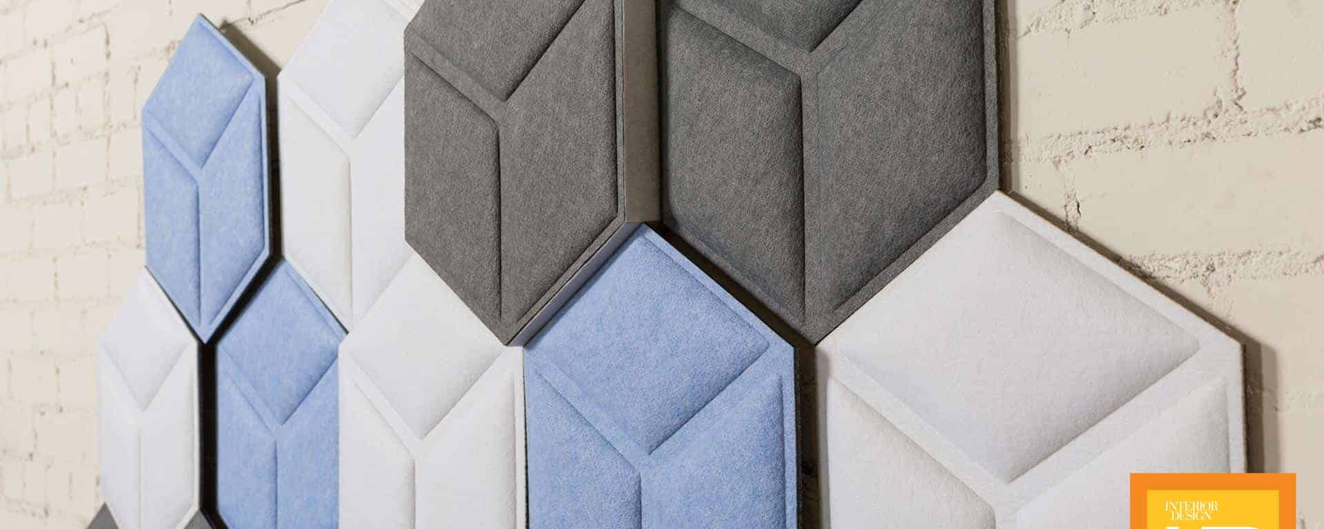 Hexagonal Acoustic Panels in Shades of Blue, Grey, and White on a Wall