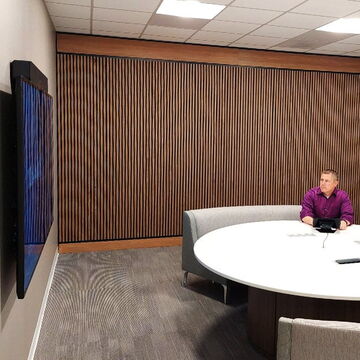 Man Sitting Alone at a Conference Table in a Modern Styled Conference Room