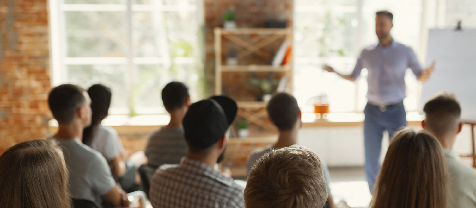 A Presenter Leading a Workshop in a Bright Modern Office Space