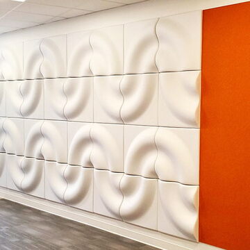 Modern Office Featuring Abstract Wall Pattern and Bright Orange Accent