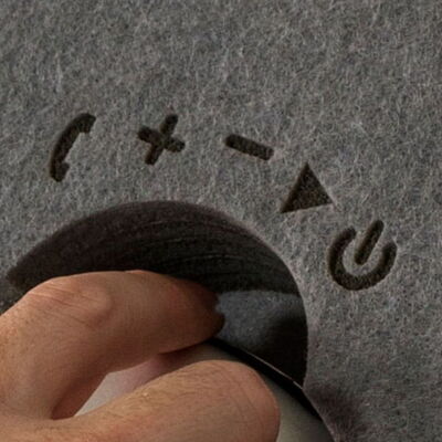 Hand Adjusting a Volume Knob with Symbols for Increase and Decrease