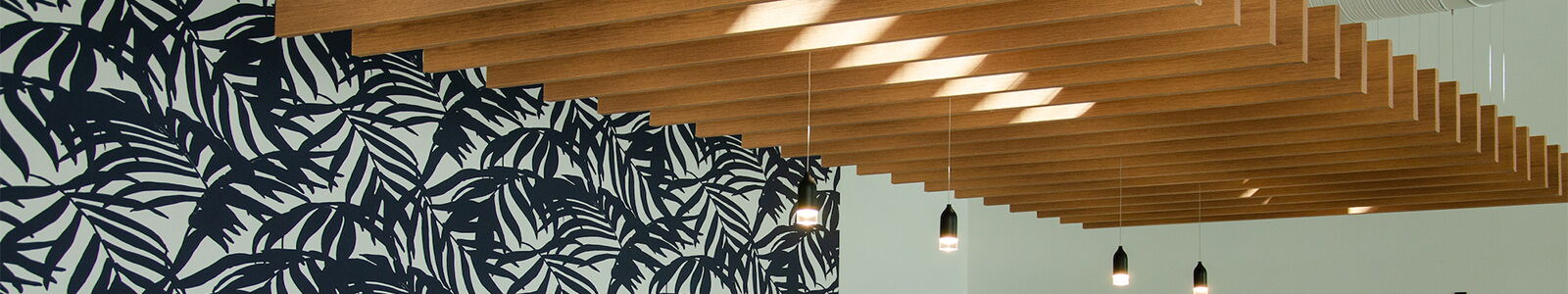 Interior Featuring Wooden Slats on Ceiling and Patterned Blue Wall