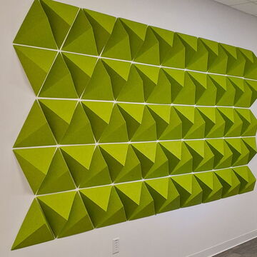 Green Geometric Acoustic Panels Mounted on a White Wall