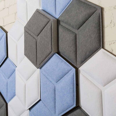 Hexagonal Acoustic Panels in Shades of Blue, Grey, and White on a Wall